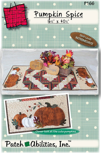 Table runner with a pieced log cabin blocks in a Barn Raising pattern with pumpkin appliques on each end.  Can be done in cotton or wool applique.