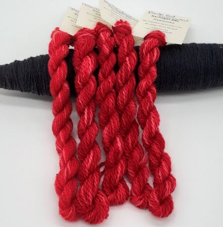 Bright red hand dyed threads in two sizes - think Santas, cardinals, flowers.  A bright happy red.