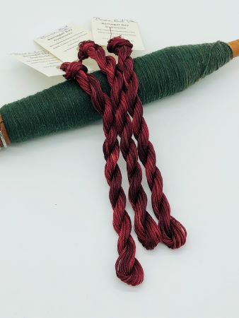 Hand dyed 6 strand cotton floss in variegated dark reds with a hint of light red