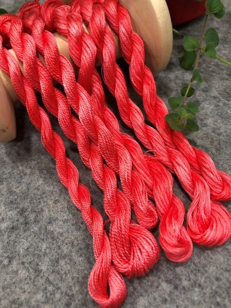 Hand dyed threads in a pinkish red, available in 6 strand embroidery floss, #12 and #8 pearl cottons.