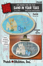 Load image into Gallery viewer, Pattern cover for Sand In Your Toes small, applique, oval mat with a sand castle, dune grass, flip flop buttons and hand embroidered &quot;Sand In Your Toes&quot;.  Applique can be done in cotton or wool.
