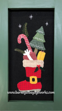 Load image into Gallery viewer, Sample made from our wool applique kit for Santa&#39;s Jolly Boot.  One red Santa boot facing left , filled with a red present with a bow, a candy cane, small evergreen tree and a yellow present.
