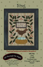 Load image into Gallery viewer, Sing wool applique on cotton wall hanging with a robins nest with eggs, a robbin and greenery on both sides with the word &quot;Sing&quot; embroidered in a small banner above the robin.
