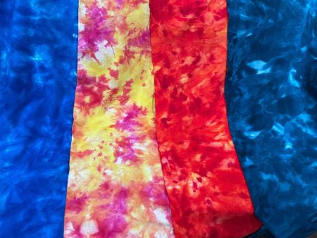 Spot Dyed and Snow Dyed wools in mottled blues,  yellow/pink/red/orange, red/yellow and dark blues with light highlights were spot dyed or snow dyed and shown in half yard pieces.
