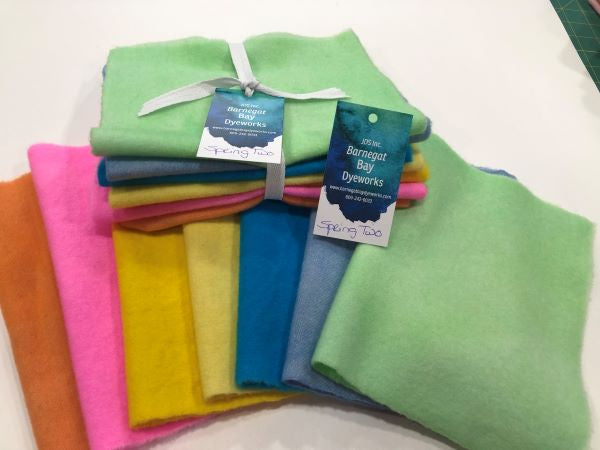 Seven pieces of hand dyed, felted, 100% wool - two yellows, two blues a green, a pink and a melon orange. 