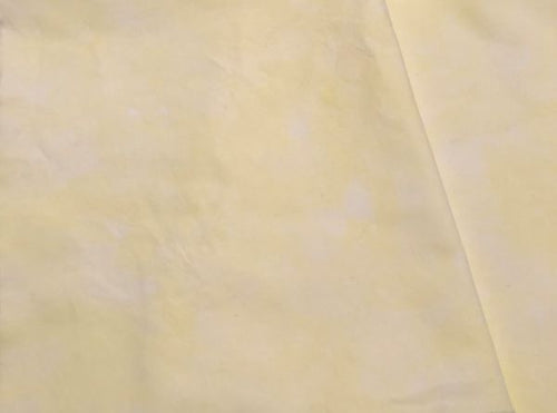Hand dyed cotton fabric in a pale to light yellow.