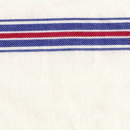 White kitchen towel with a  thin and then thicker stripe of blue, a red stripe, then a thick and thin repeat of blue 