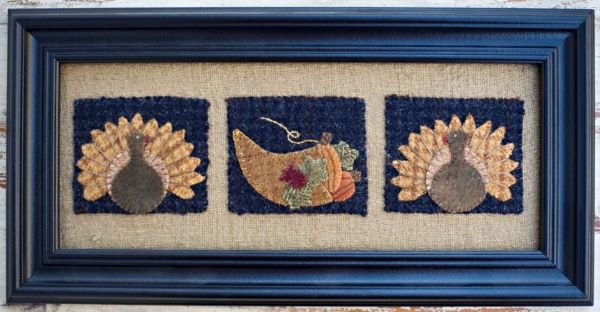Twp turkeys and a cornucopia decorate this Fall themed wool applique design by Bits and Pieces by Joan.