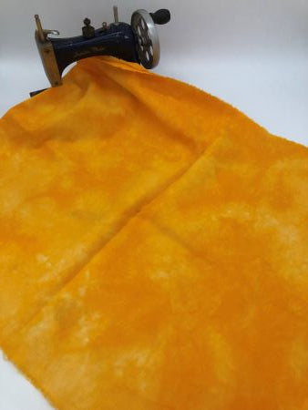 A bright, happy golden yellow hand dyed linen with mottling.