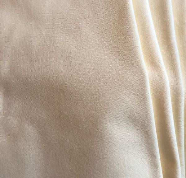 Hand dyed cotton fabric in a pale yellow.