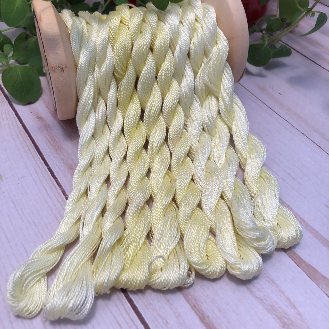 hand dyed threads in a pale yellow color.  Available in floss, #12 and #8 pearl cottons