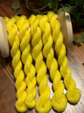 Load image into Gallery viewer, Five skeins of hand dyed sunny yellow wool thread draped over a vintage spool 
