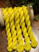 Load image into Gallery viewer, Five skeins of hand dyed sunny yellow wool thread draped over a vintage spool 
